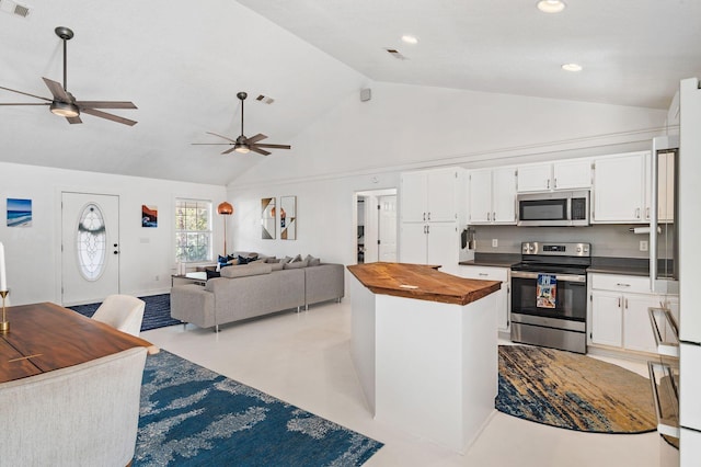 kitchen featuring white cabinetry, ceiling fan, stainless steel appliances, wood counters, and high vaulted ceiling