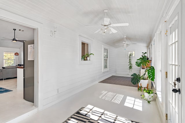 hall with wood walls and wooden ceiling