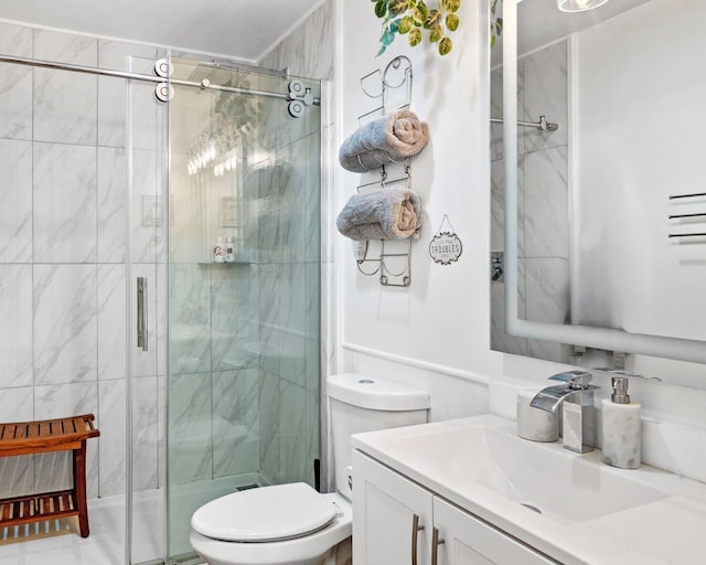 bathroom with vanity, toilet, and a shower with shower door