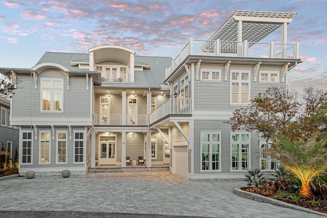 back house at dusk with a balcony