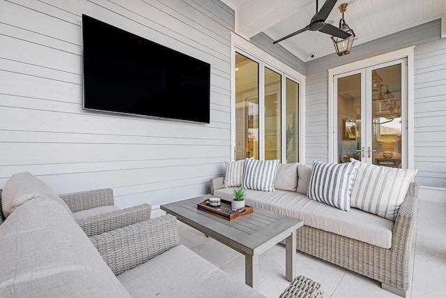 living room with wood walls, ceiling fan, beamed ceiling, and wooden ceiling