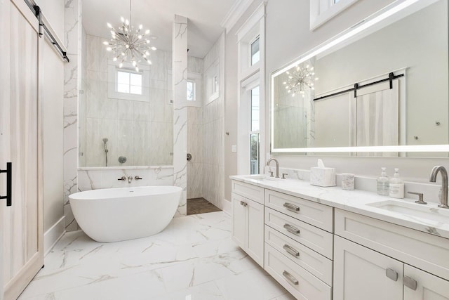 bathroom with an inviting chandelier, independent shower and bath, and vanity