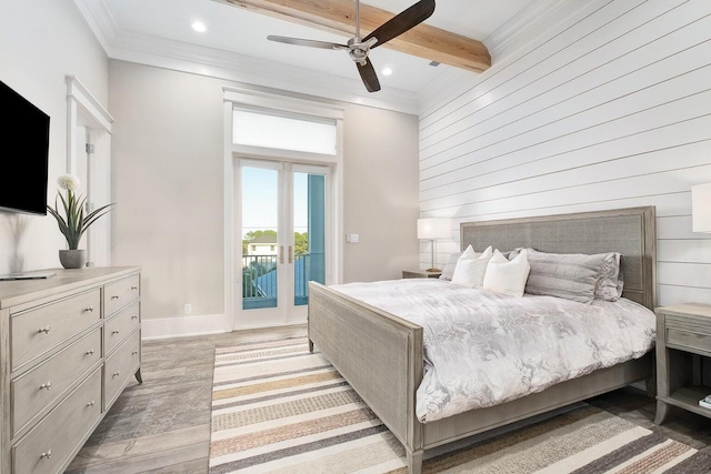 bedroom with wood walls, beamed ceiling, access to exterior, light wood-type flooring, and ceiling fan