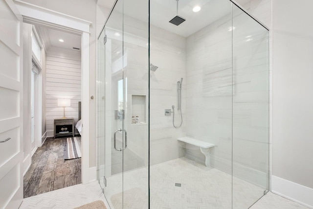 bathroom with hardwood / wood-style floors and an enclosed shower