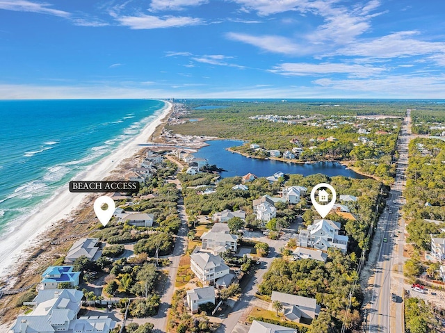 birds eye view of property featuring a water view and a beach view