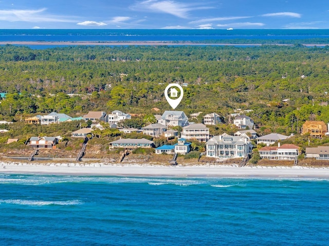 bird's eye view with a water view and a beach view