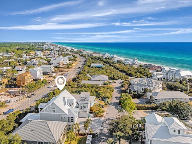 aerial view with a water view and a beach view