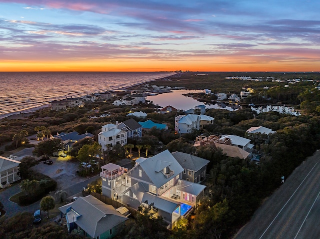 aerial view at dusk with a water view