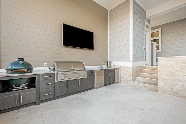 view of patio featuring an outdoor kitchen, sink, and a grill