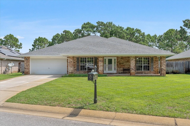 single story home with brick siding, a shingled roof, concrete driveway, an attached garage, and a front lawn