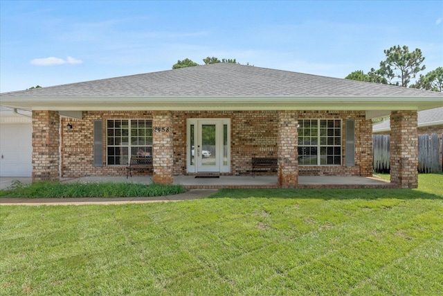 2458 Abaco Dr, Navarre, FL 32566 - view of front of house featuring roof with shingles, a front lawn, a porch, a garage, and brick siding