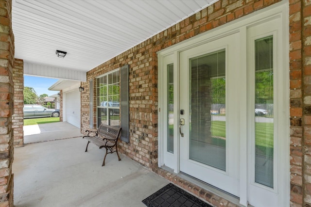 view of patio featuring a garage and a porch