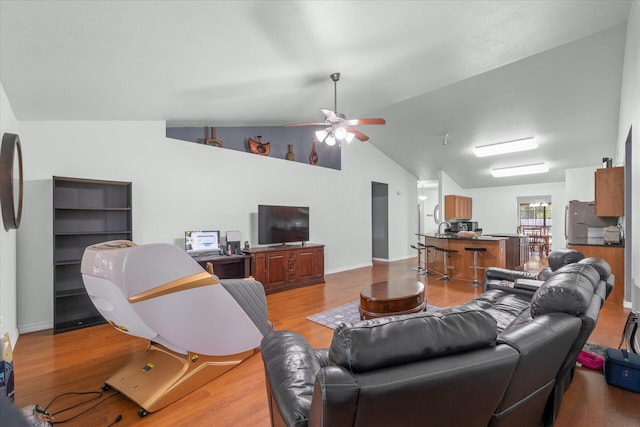 living room featuring hardwood / wood-style floors, high vaulted ceiling, and ceiling fan