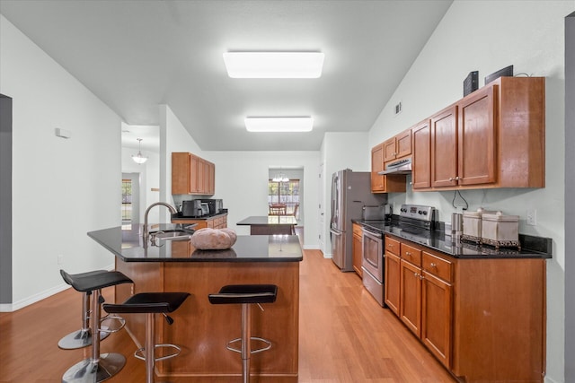 kitchen with a kitchen bar, light wood-type flooring, stainless steel range with electric stovetop, kitchen peninsula, and lofted ceiling