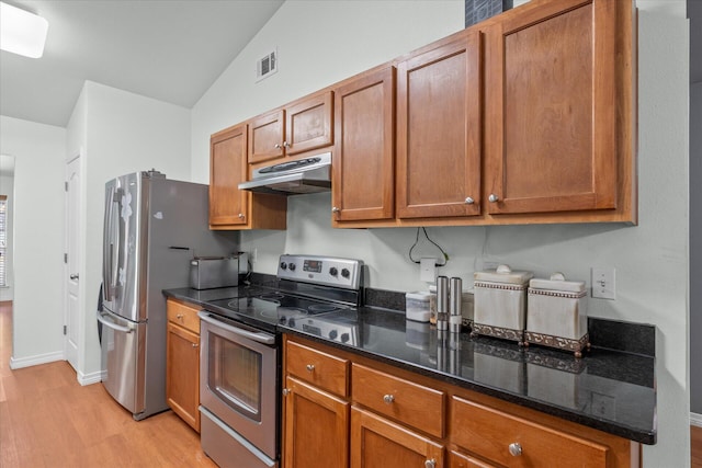 2458 Abaco Dr, Navarre, FL 32566 - kitchen with brown cabinets, under cabinet range hood, stainless steel appliances, visible vents, and light wood-style flooring