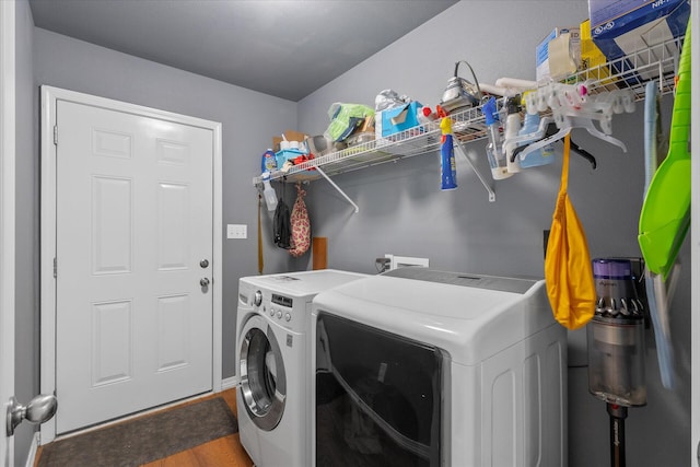 laundry area featuring hardwood / wood-style flooring and separate washer and dryer