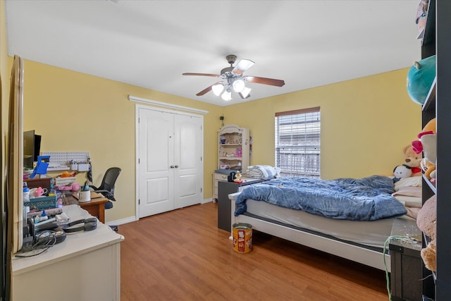 bedroom featuring ceiling fan, wood-type flooring, and a closet