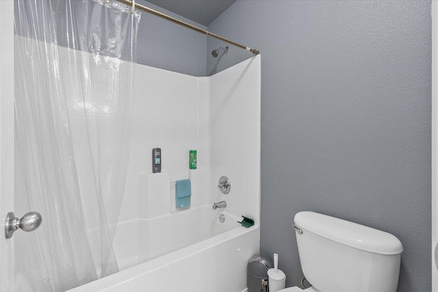 bathroom with shower / bath combination with curtain and toilet