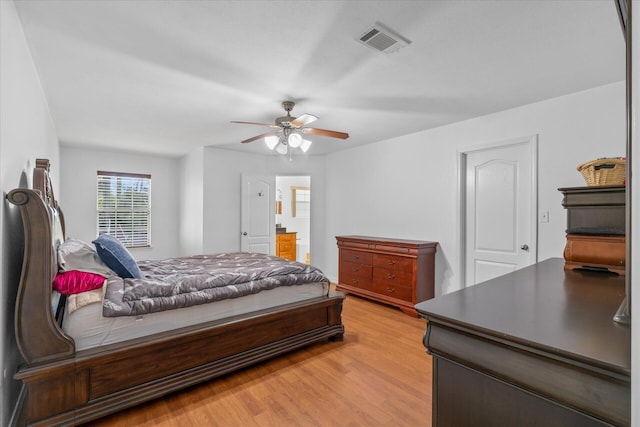 bedroom featuring ceiling fan, light wood-type flooring, and ensuite bathroom