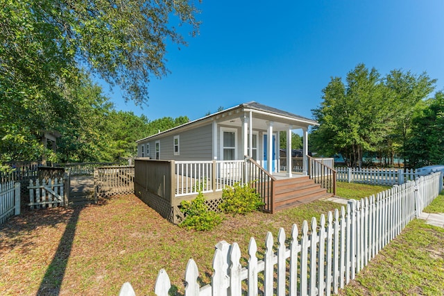 view of front of home with a front lawn and a deck