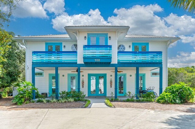 view of front facade with a balcony and french doors