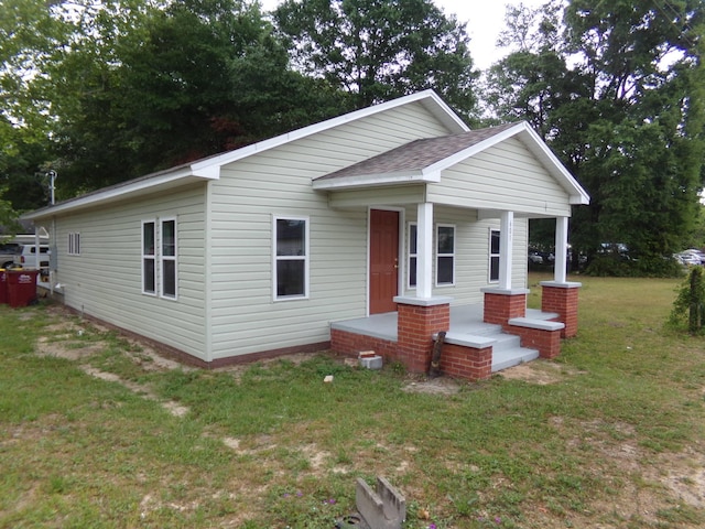 view of front of home with a front lawn and covered porch