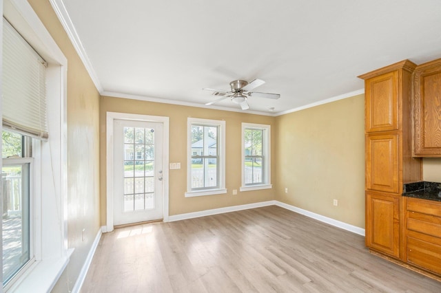 interior space featuring ceiling fan, crown molding, and light wood-type flooring