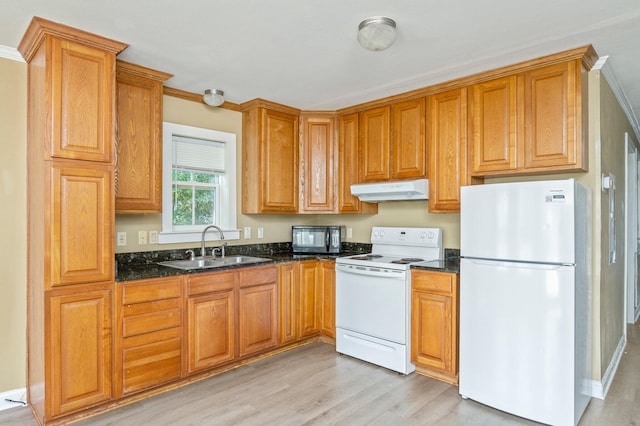 kitchen featuring dark stone counters, light hardwood / wood-style flooring, ornamental molding, sink, and white appliances