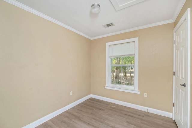 spare room with crown molding and light wood-type flooring