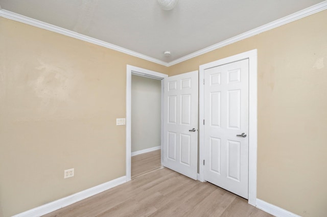 unfurnished bedroom with light hardwood / wood-style flooring and ornamental molding