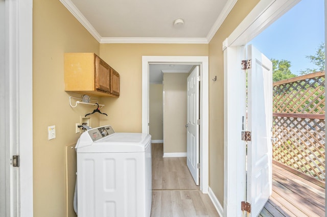 laundry area featuring washing machine and dryer, cabinets, light hardwood / wood-style floors, and ornamental molding