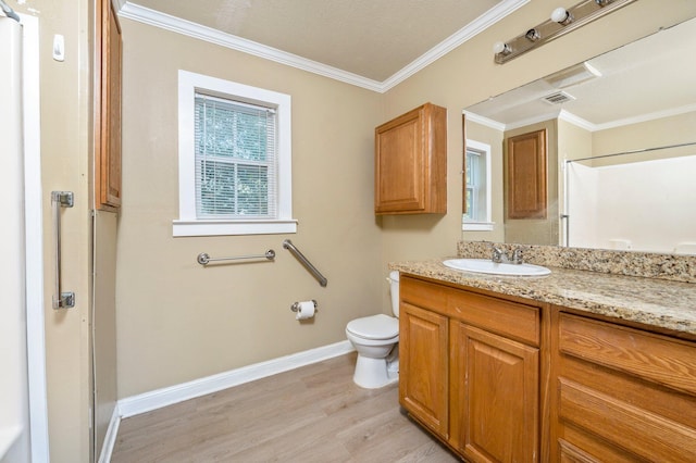 bathroom with hardwood / wood-style flooring, ornamental molding, vanity, and toilet