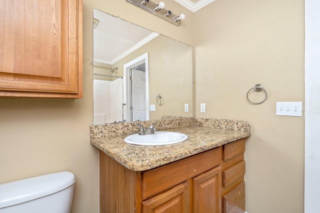 bathroom featuring toilet, crown molding, and vanity