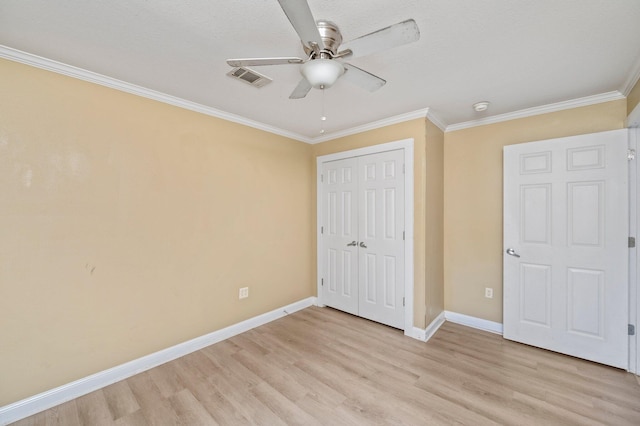 unfurnished bedroom featuring a closet, ceiling fan, ornamental molding, and light wood-type flooring