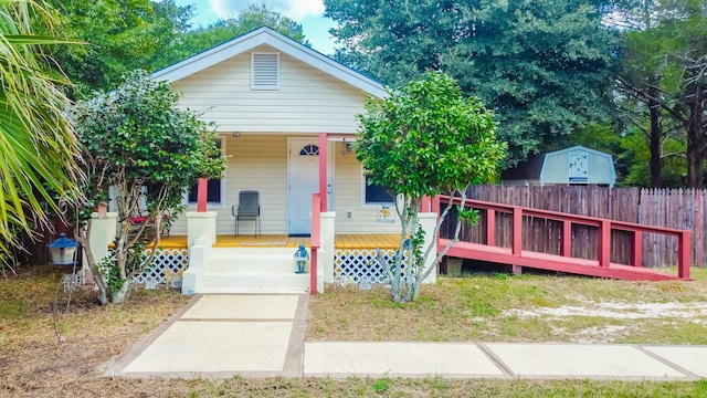 view of front of house with a shed and a porch