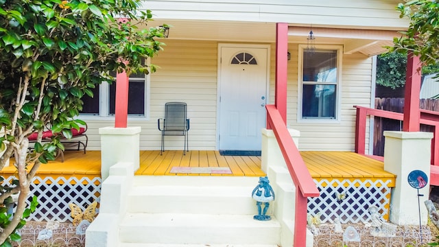 view of exterior entry with covered porch