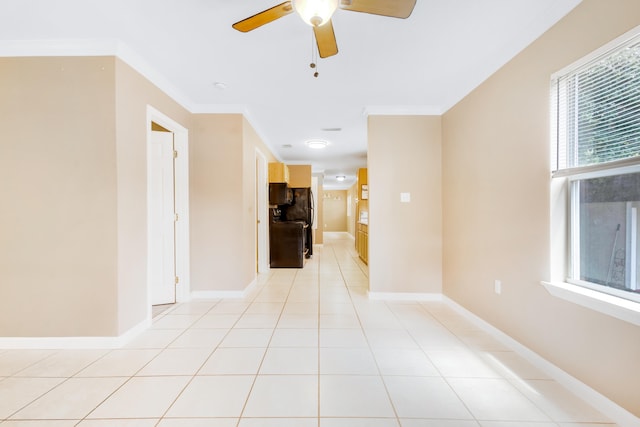 corridor featuring ornamental molding and light tile patterned floors