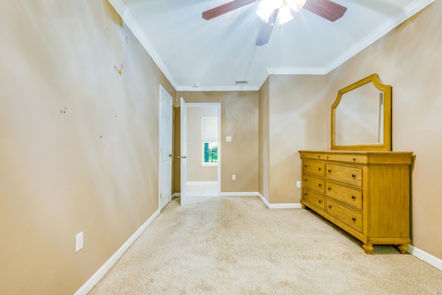 unfurnished bedroom with ceiling fan, ornamental molding, and light carpet