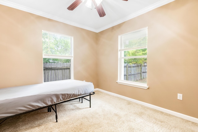 bedroom with crown molding, carpet, and ceiling fan