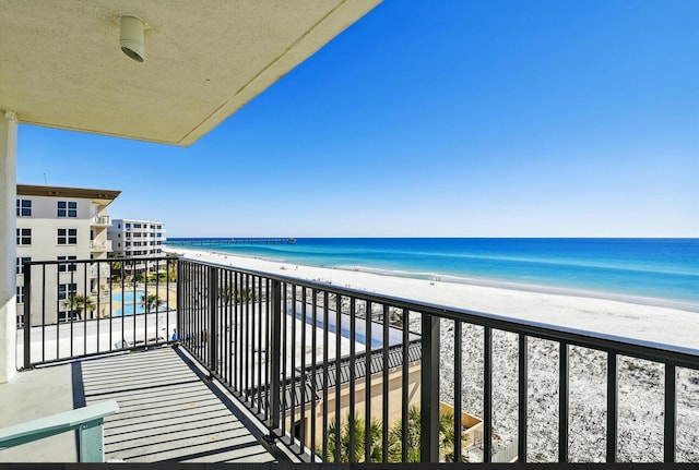 balcony with a view of the beach and a water view