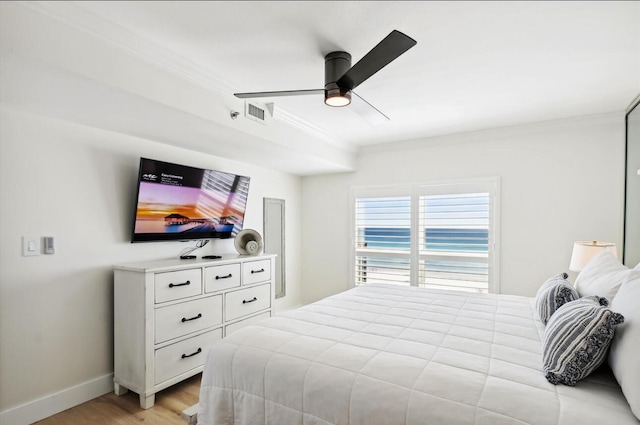 bedroom featuring ceiling fan, light hardwood / wood-style flooring, and ornamental molding