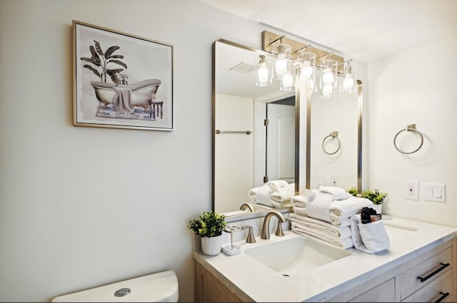 bathroom with toilet and vanity