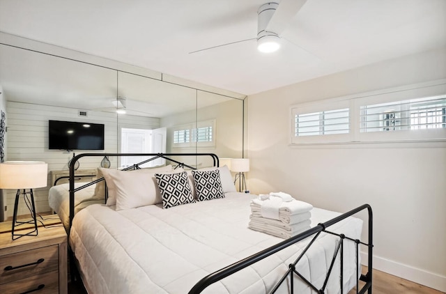 bedroom with a closet, ceiling fan, and light wood-type flooring