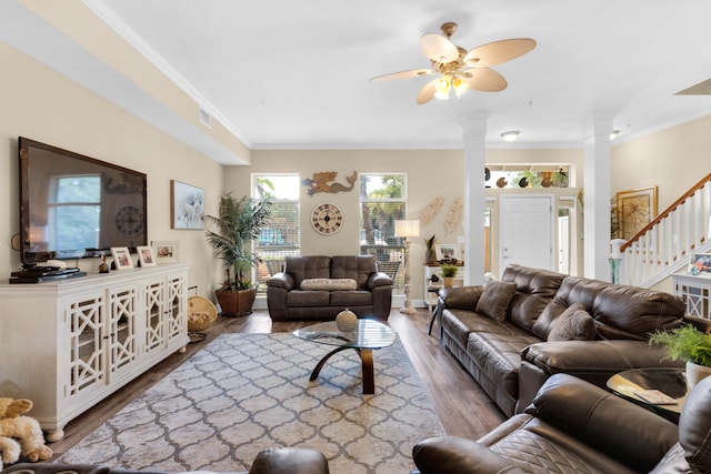 living room featuring ceiling fan, crown molding, hardwood / wood-style floors, and ornate columns