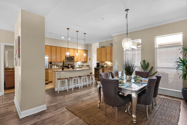 dining room featuring a notable chandelier, wood-type flooring, and ornamental molding