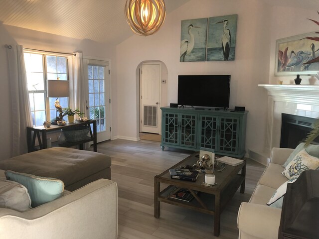 living room featuring lofted ceiling and hardwood / wood-style floors