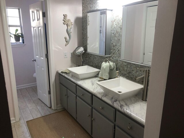 bathroom with vanity and backsplash