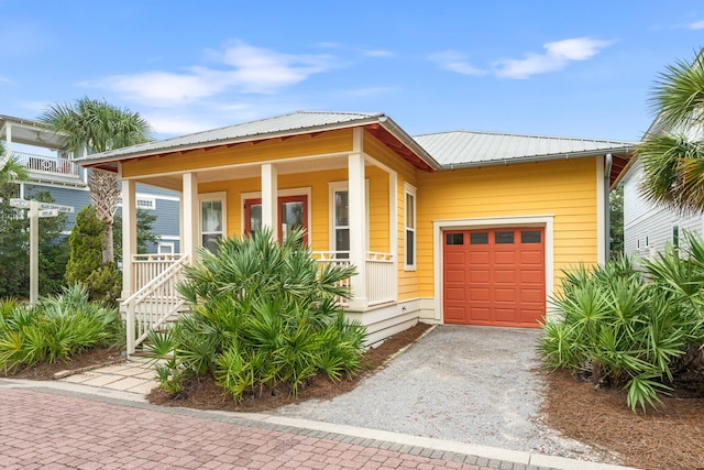 view of front of property with covered porch and a garage