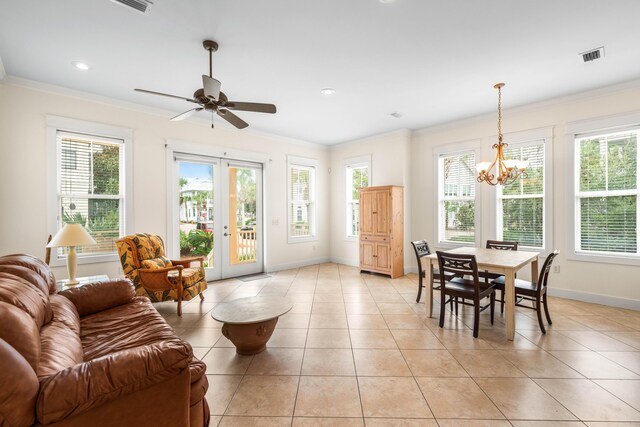 dining space with ceiling fan with notable chandelier, light tile patterned flooring, and ornamental molding