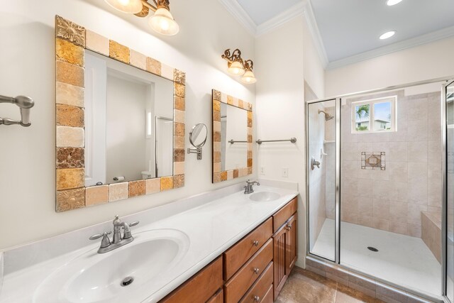 bathroom featuring tile patterned floors, a shower with door, ornamental molding, and vanity